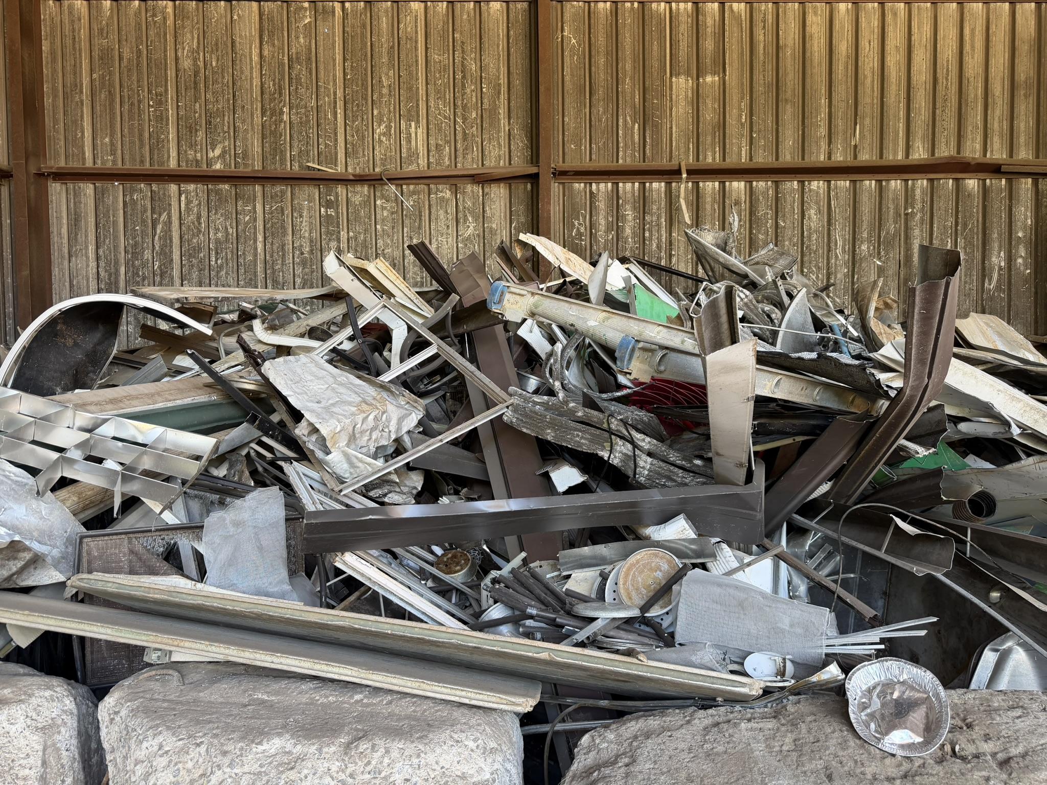 Clean aluminum sheet, siding and window frame stacked separately from the mixed pile